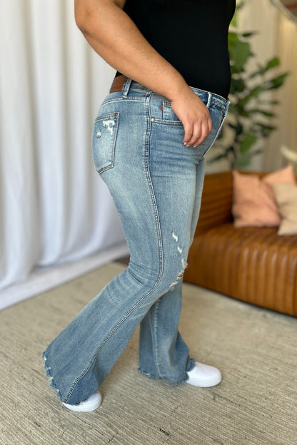 a woman in black shirt and jeans standing in a room