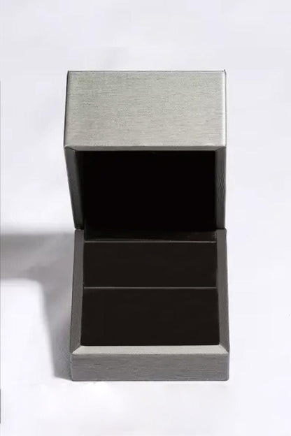 Shiny stainless steel and sleek black ring box showcasing a modern, elegant design perfect for displaying a precious 1 Carat Moissanite 925 Sterling Silver Ring.