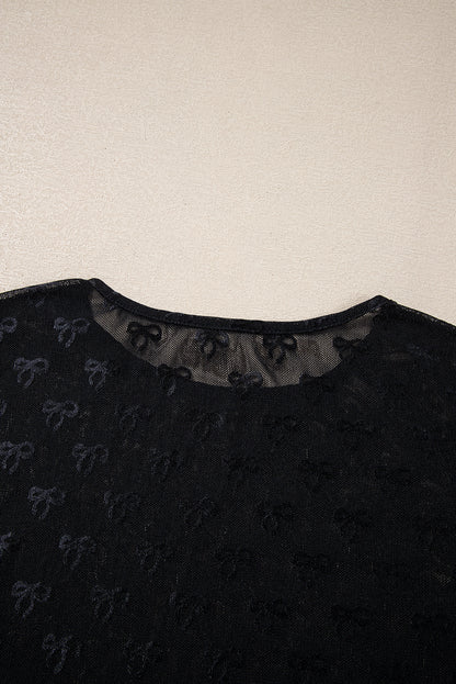 a black shirt with bows on the collar