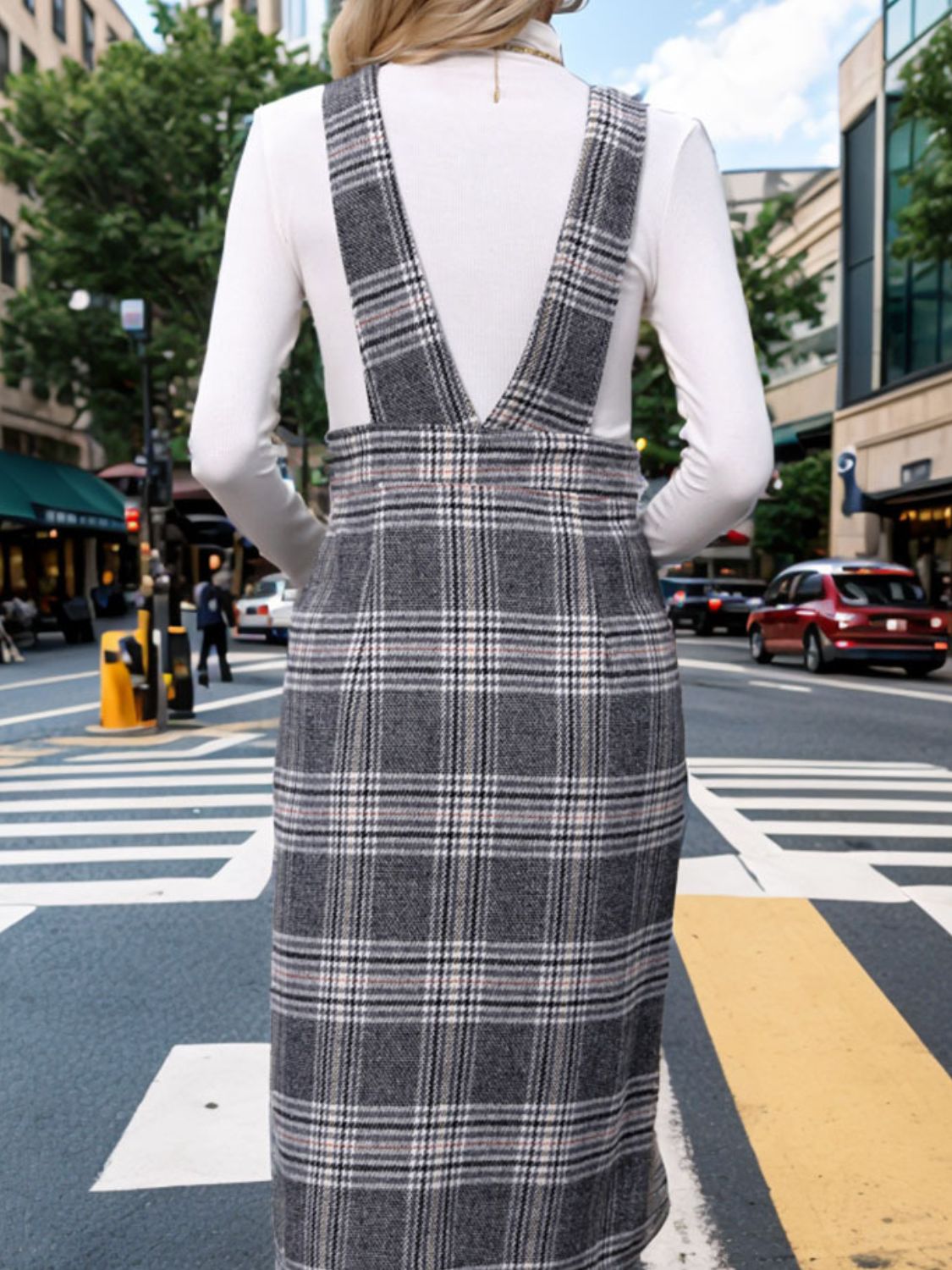 a woman standing on the side of a street