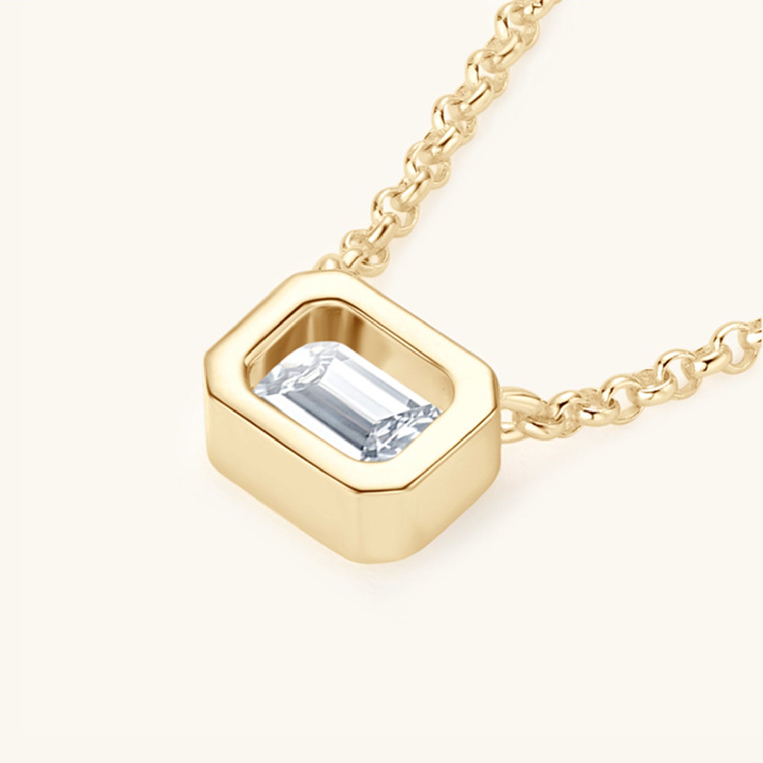 Elegant gold-tone pendant necklace featuring a square-shaped Moissanite gemstone set in a sterling silver frame, presented on a delicate chain.