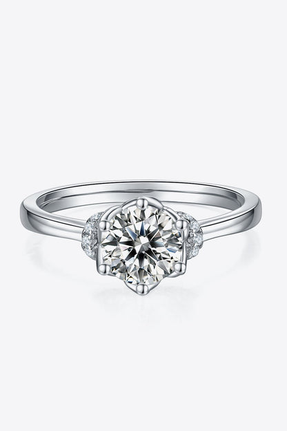 Elegant diamond ring with floral accent design. Stunning 1 carat round moissanite center stone set in 925 sterling silver.