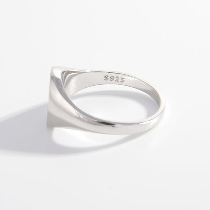 a white gold signet ring on a white background