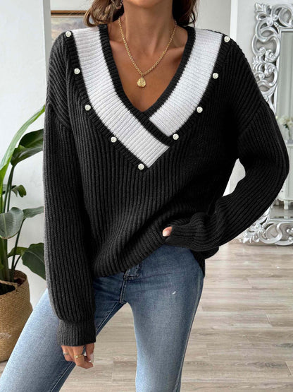 a woman wearing a black and white sweater