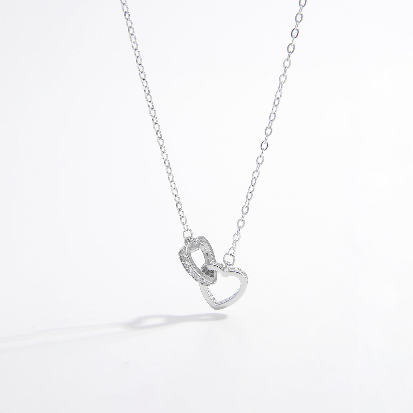 a silver necklace with a heart on it