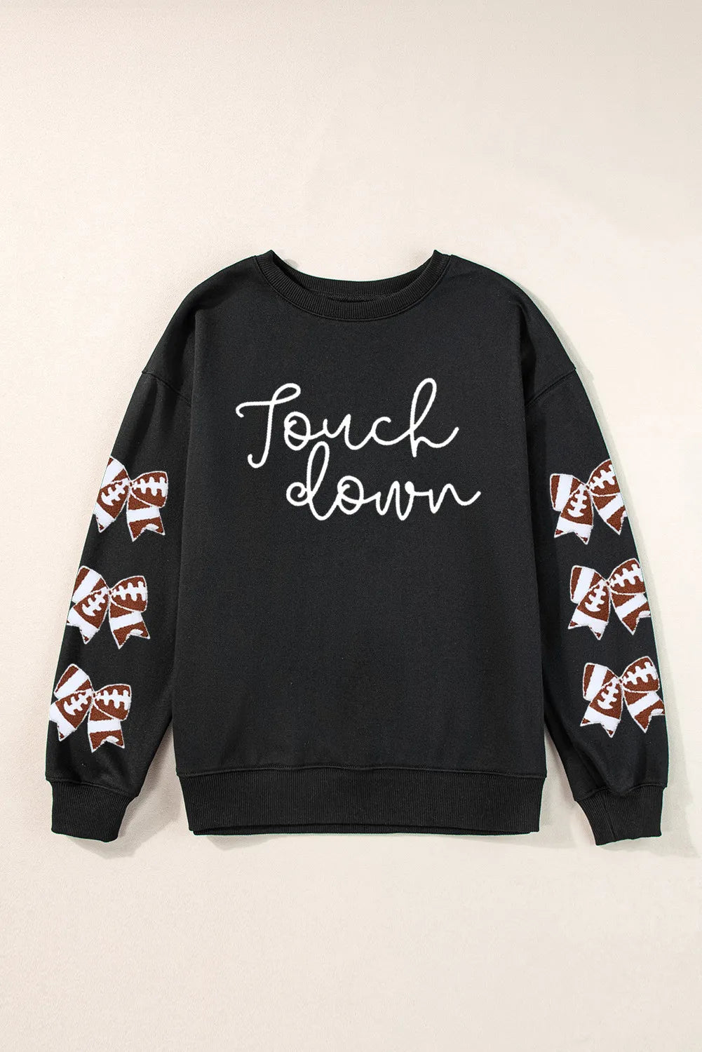 a black sweatshirt with a football design on it