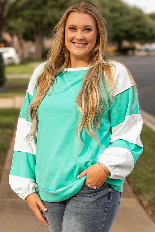 a woman standing on a sidewalk with her hands in her pockets