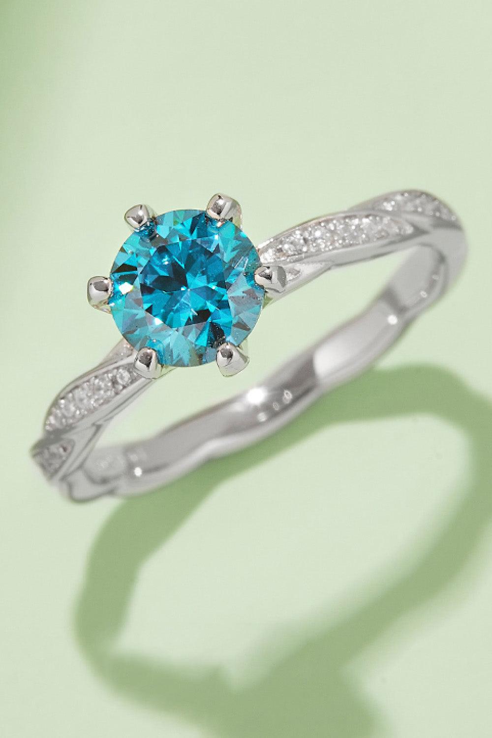 Dazzling Moissanite Engagement Ring: Stunning 1 carat blue moissanite center stone set in a silver band with sparkling accents