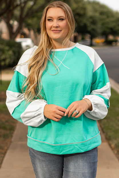 a woman standing on a sidewalk with her hands in her pockets