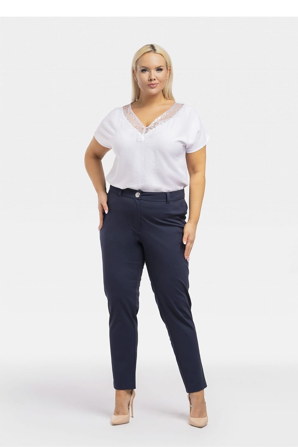 a woman in a white shirt and blue pants