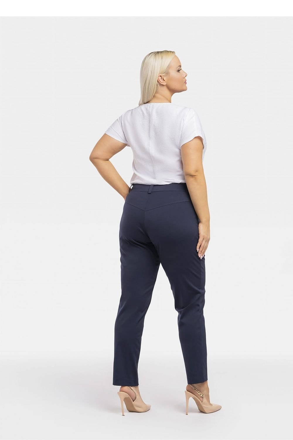 a woman in a white shirt and blue pants