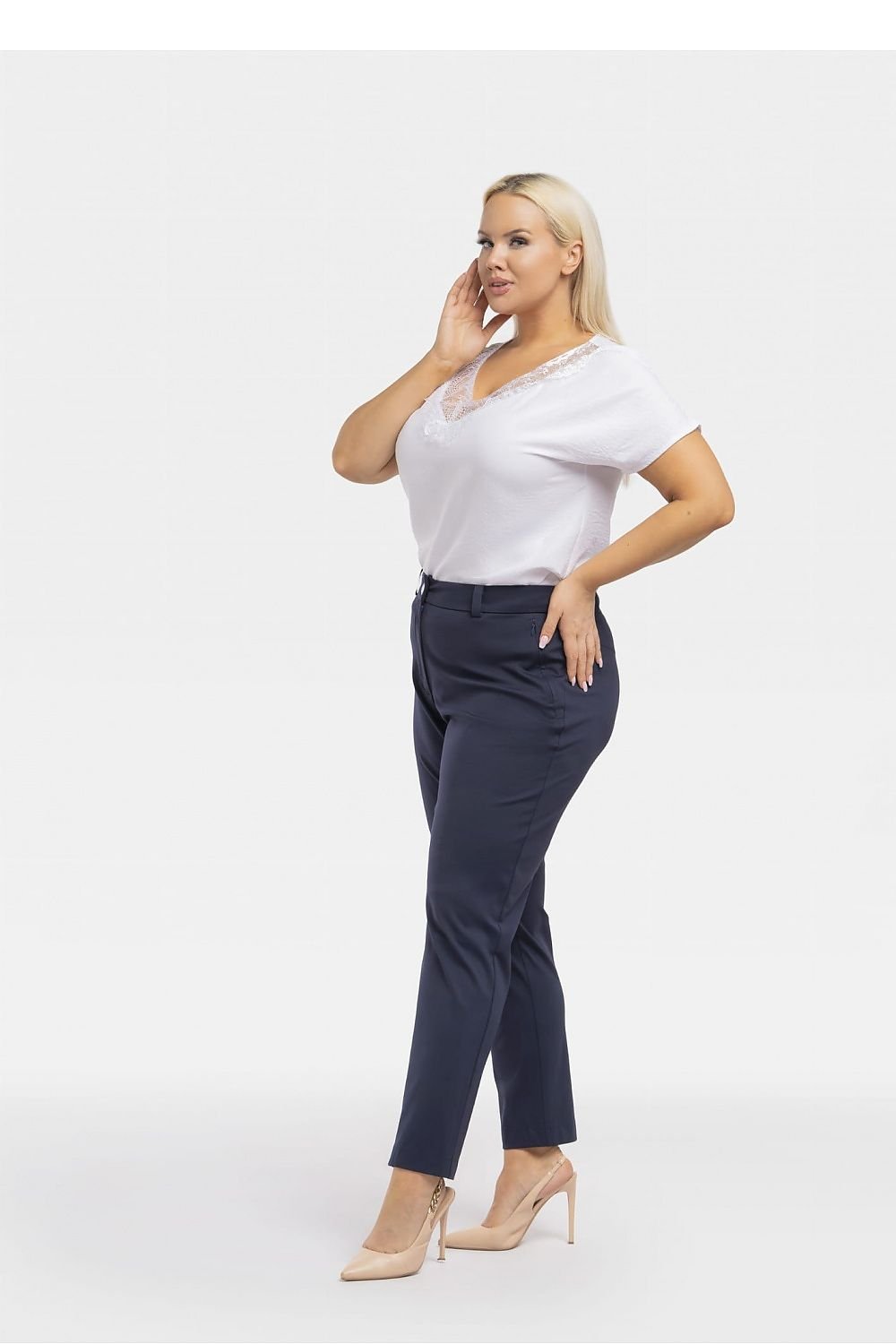 a woman in a white shirt and blue pants