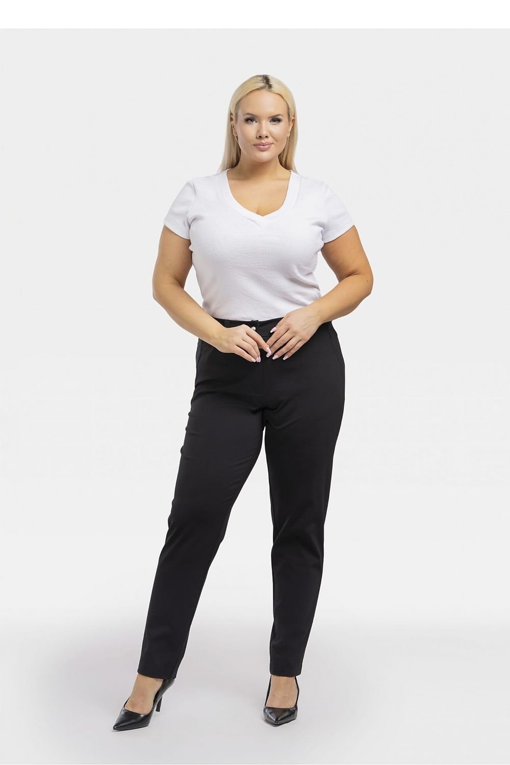 a woman in a white shirt and black pants