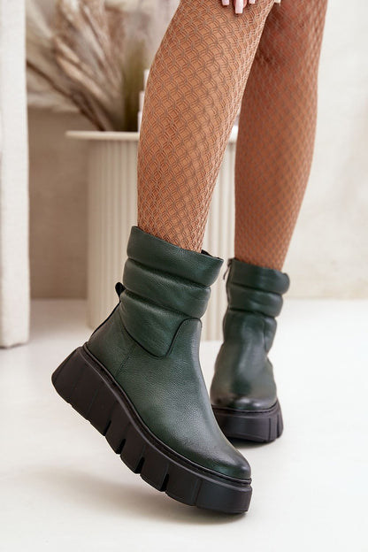 a close up of a person wearing green boots