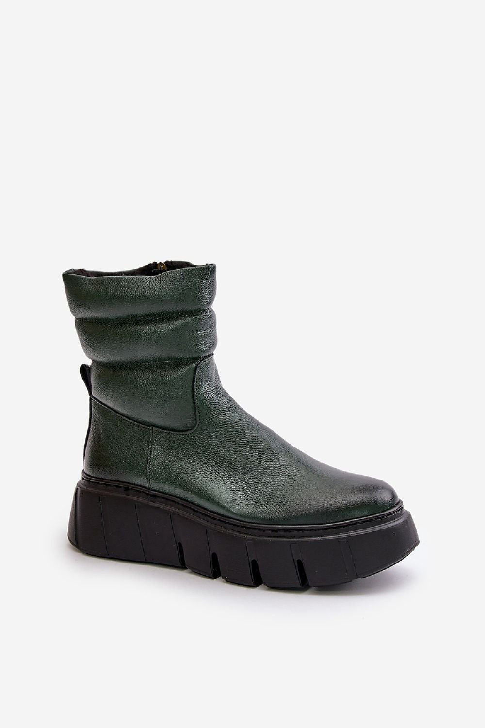 a pair of green boots with black soles