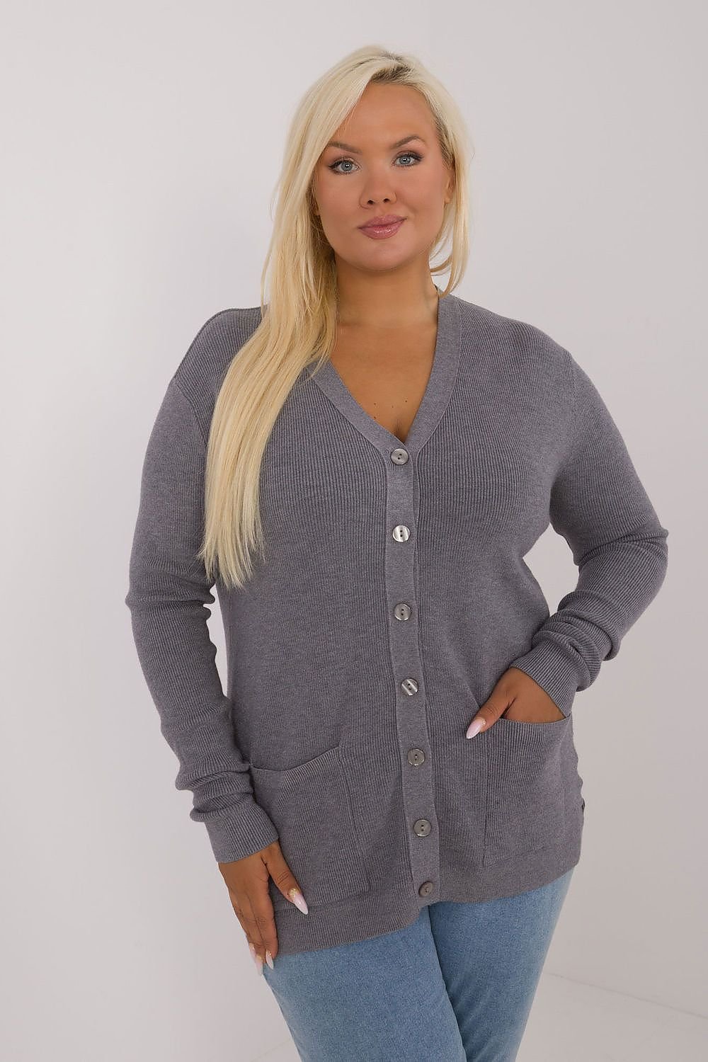 a woman wearing a grey cardigan sweater and jeans