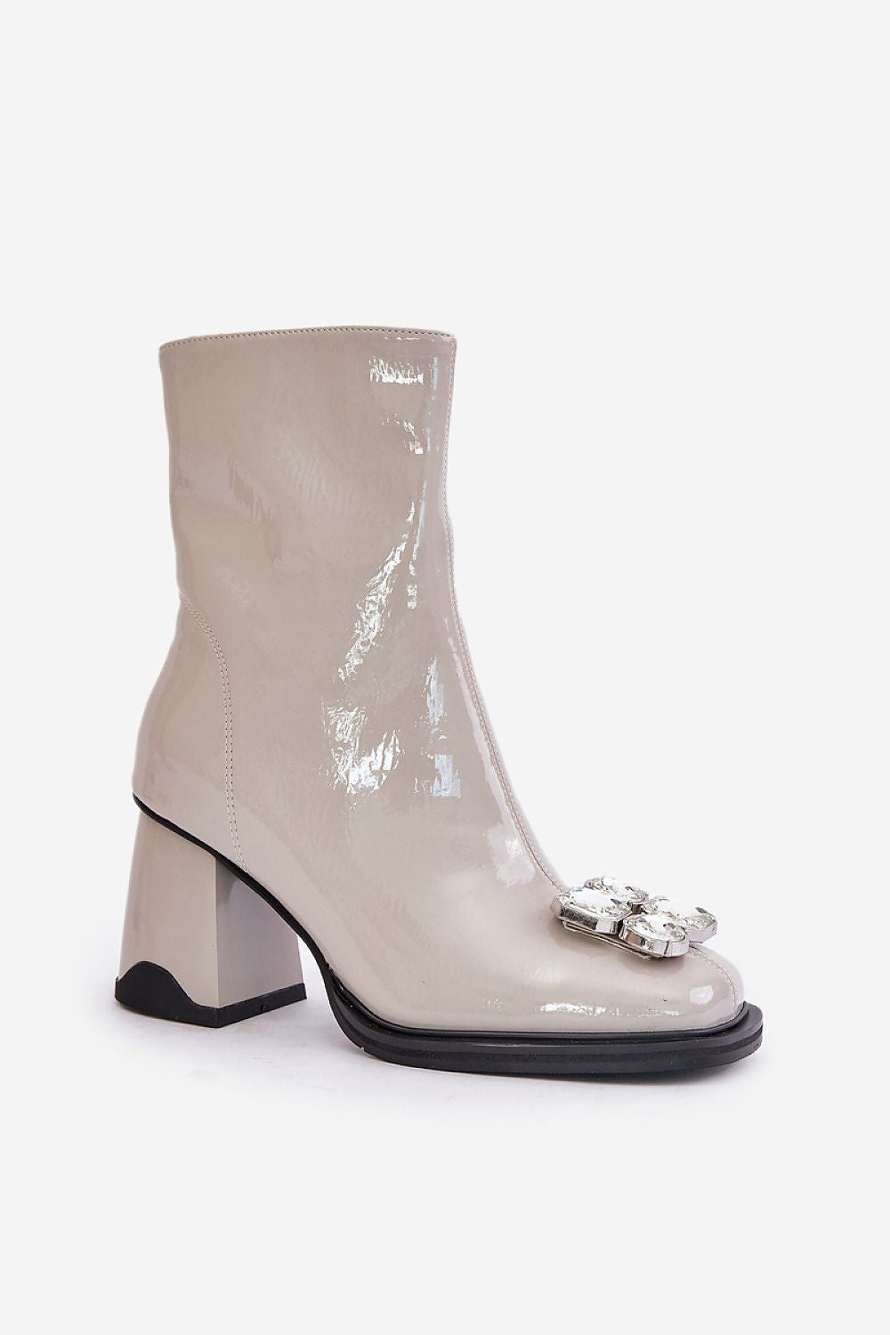 a woman's white boot with a flower on the side