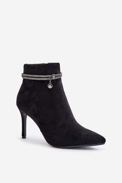 a black high heeled shoe with a chain around the ankle