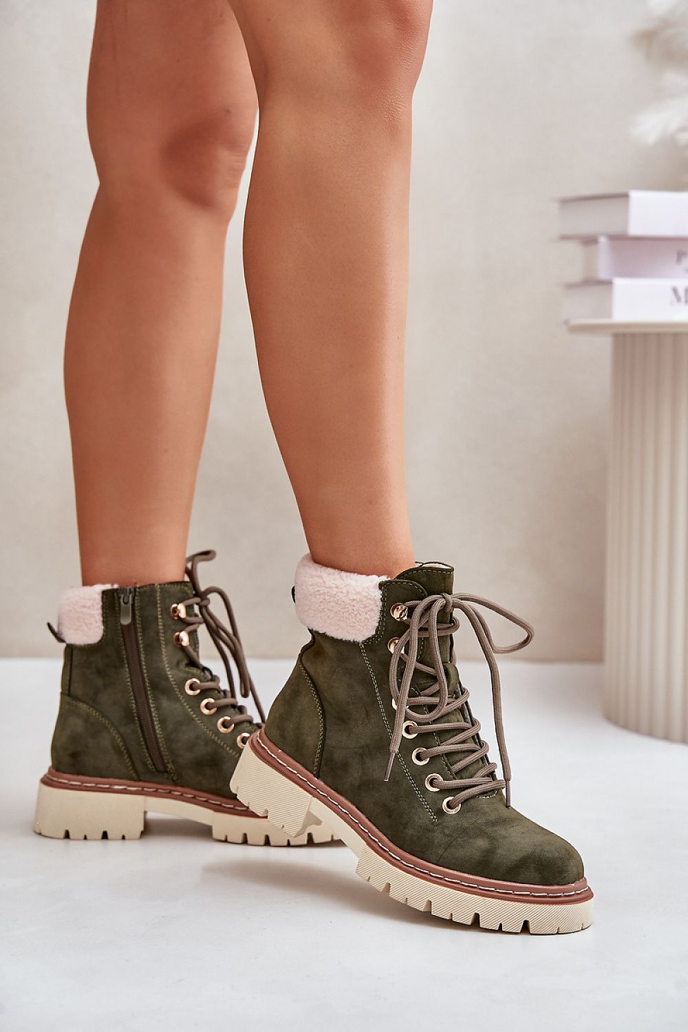 a pair of legs with a pair of green boots