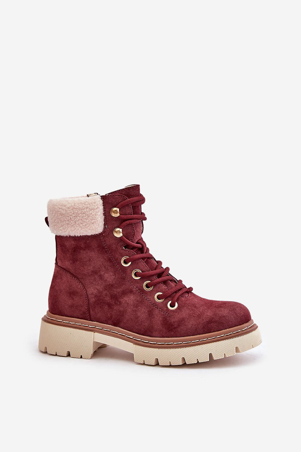 a pair of red boots with a fur lined sole