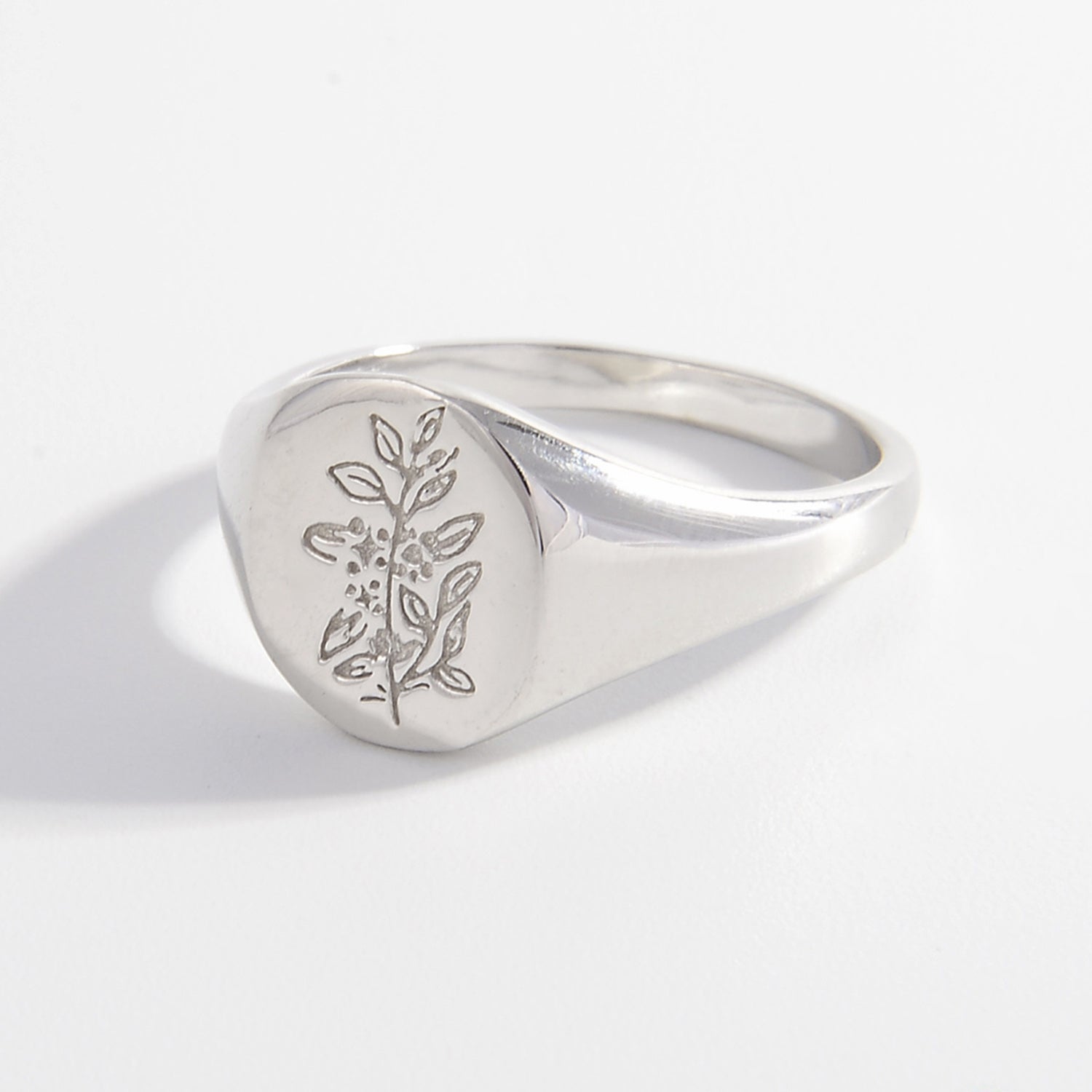 a silver signet ring with a tree on it