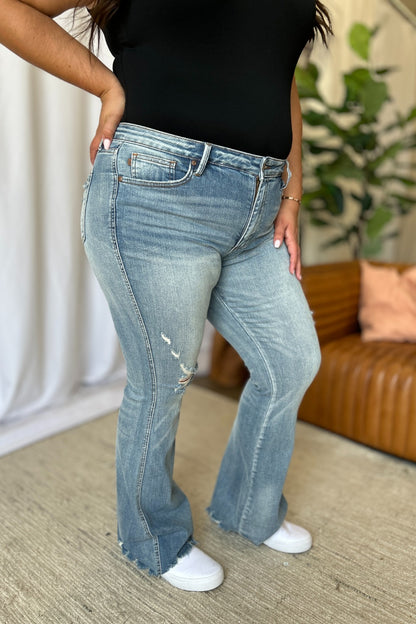 a woman in a black shirt and jeans posing for a picture