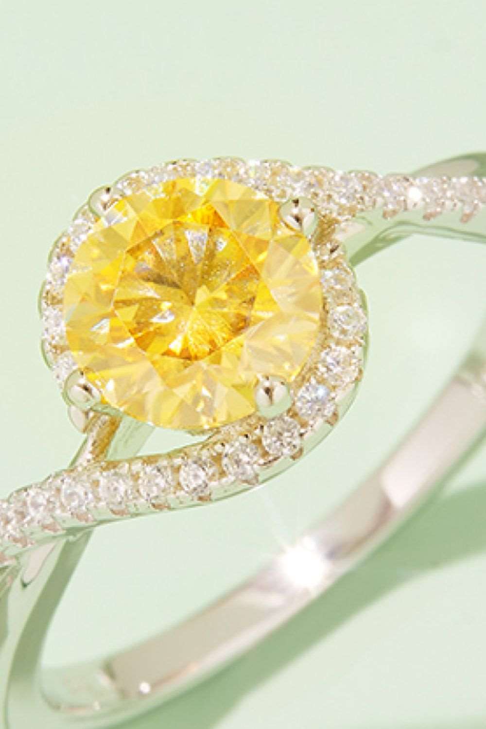 Brilliant yellow moissanite gemstone in sterling silver halo setting