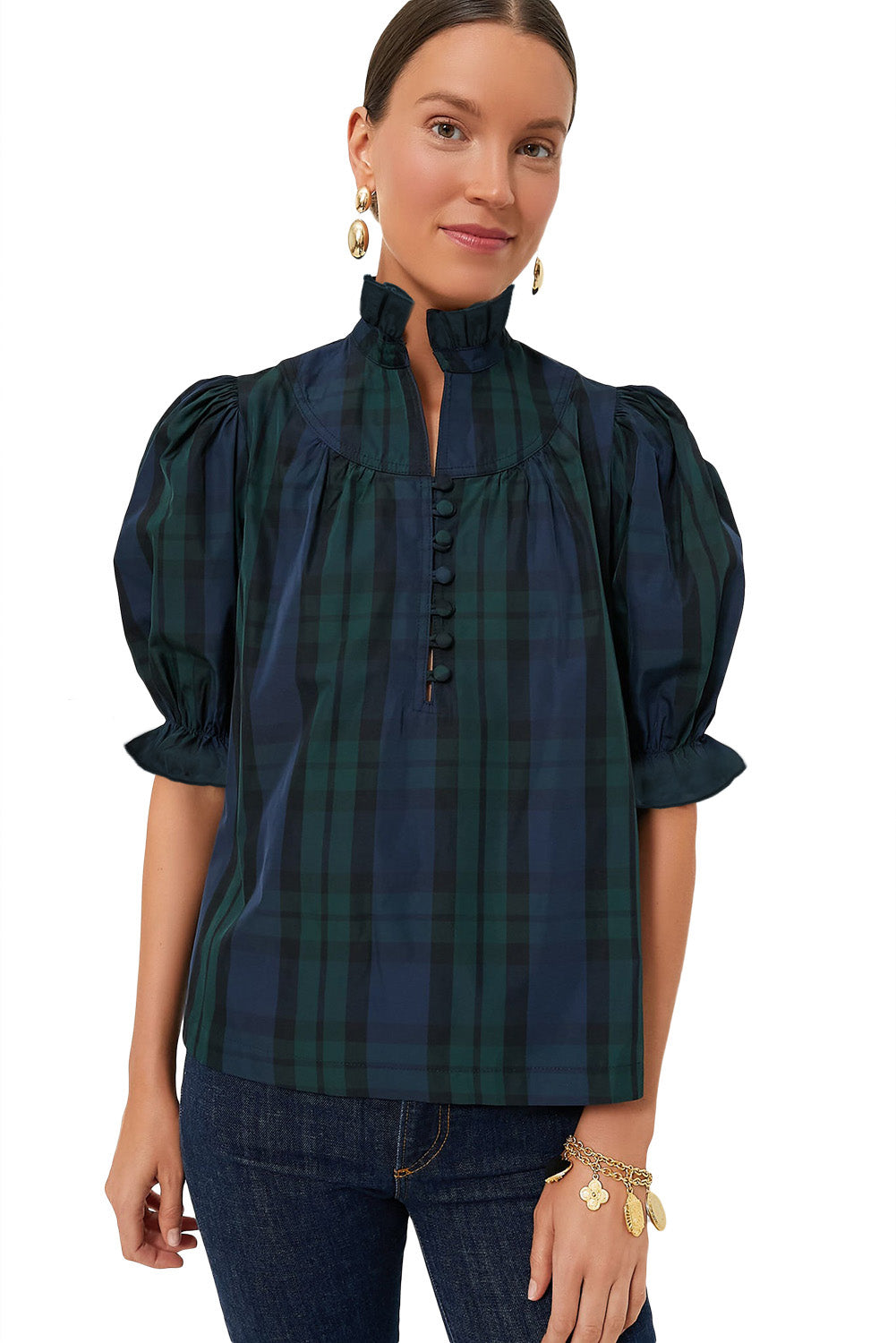 a woman wearing a green and black plaid top