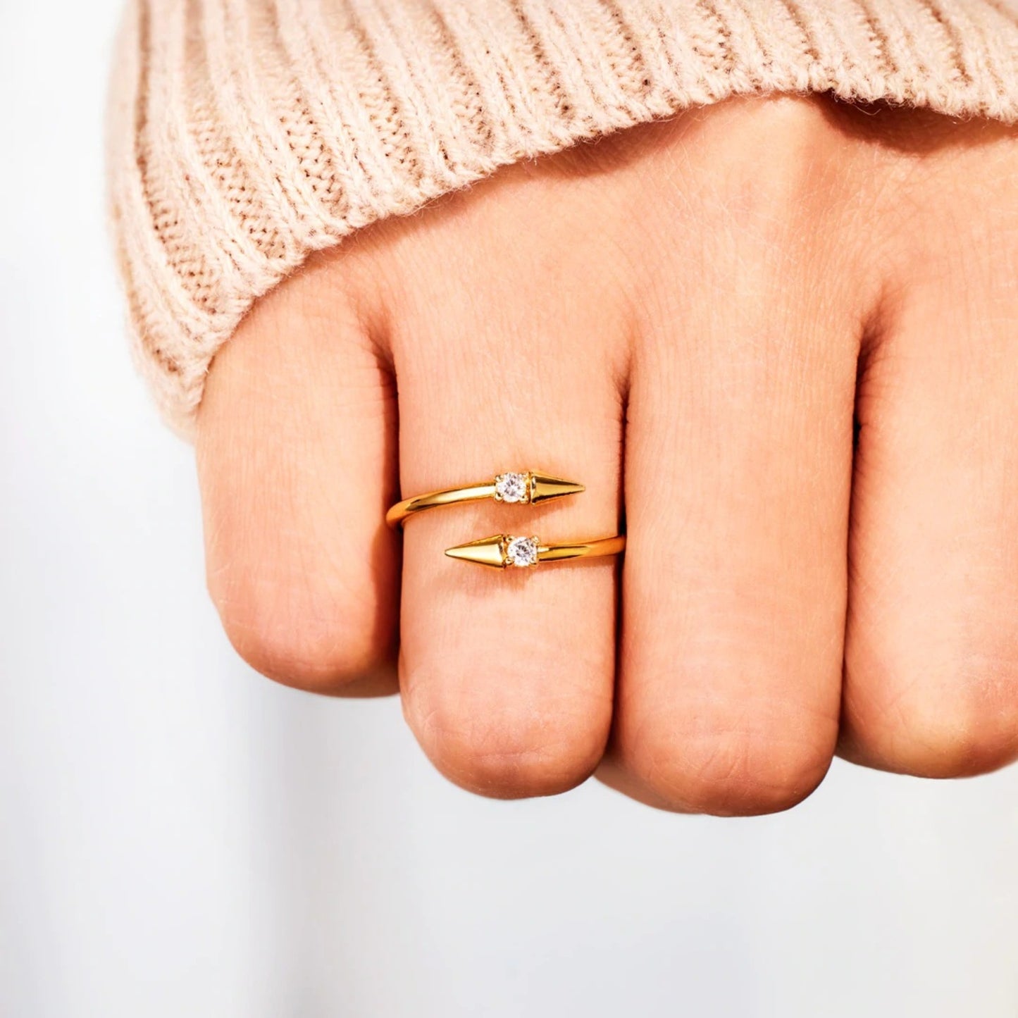 a person's hand with two rings on it