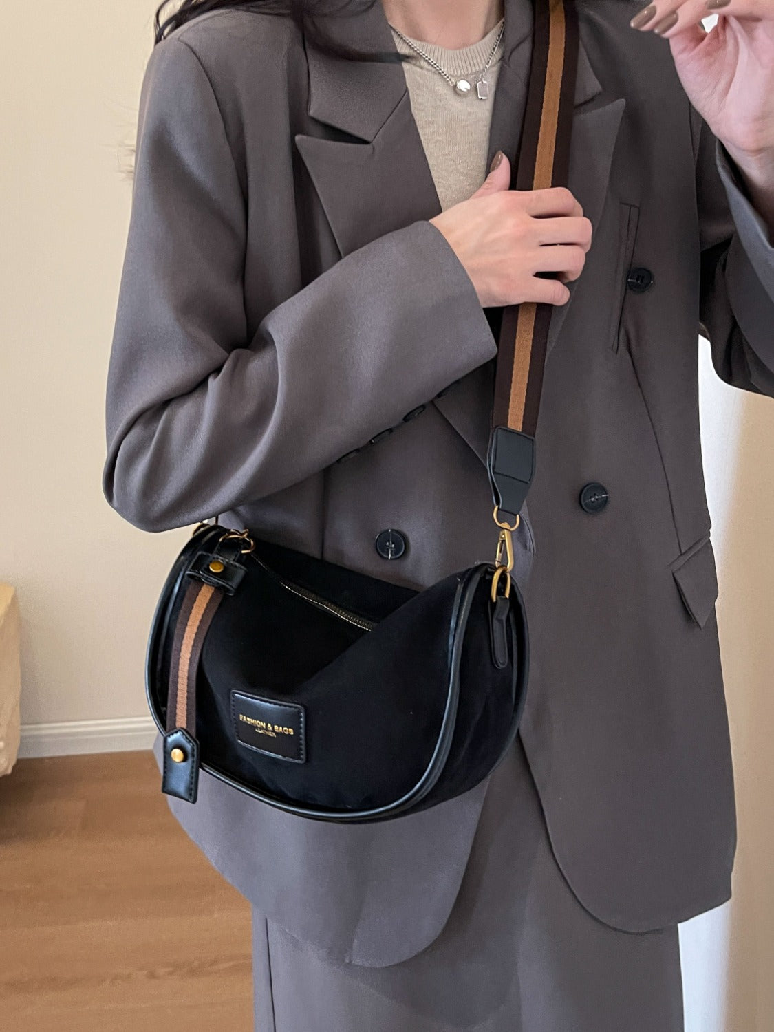 a woman holding a black purse and smoking a cigarette